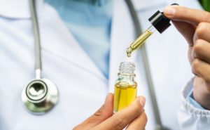 medical cannabis tincture being dripped from a dropper by a medical marijuana doctor