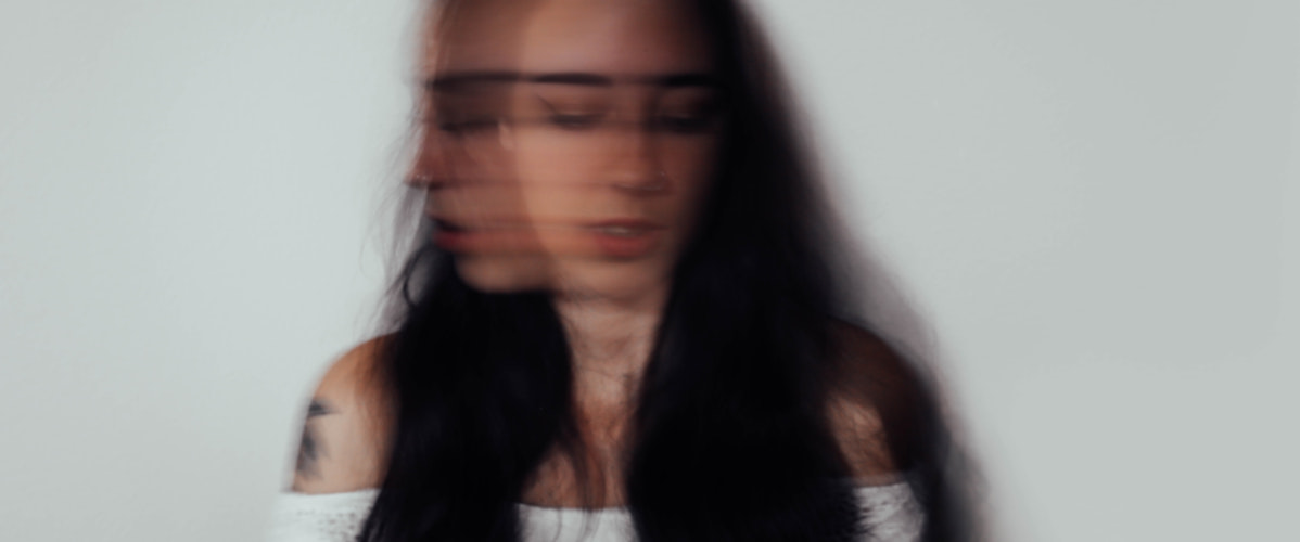 blurry image of a woman showing ptsd symptoms