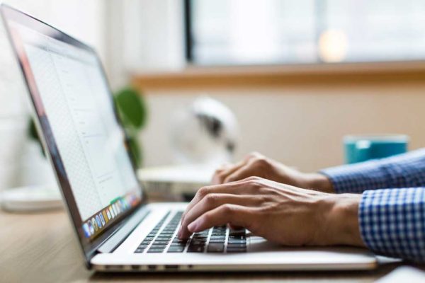 A person typing on a computer