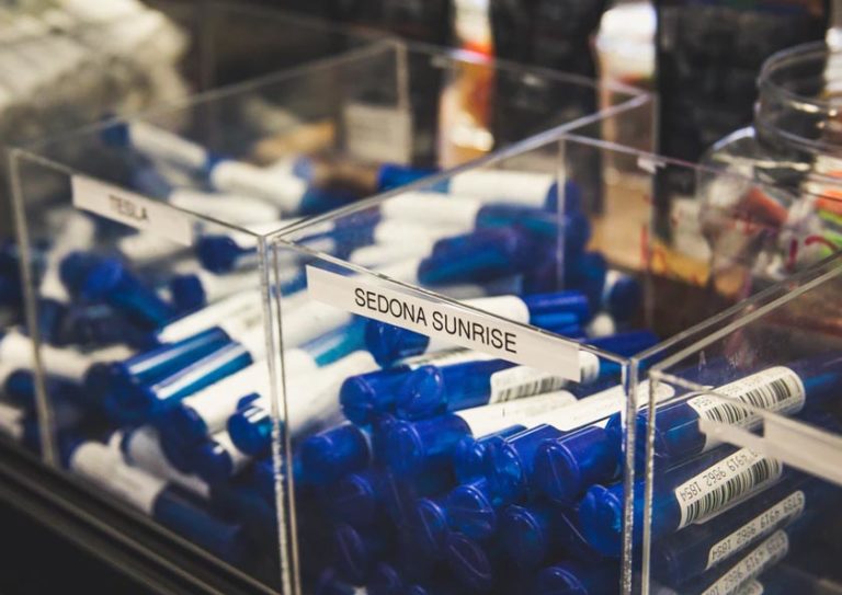 Tubes containing cannabis sorted and labeled for sale in a dispensary.