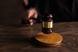 A brown wooden gavel on a table