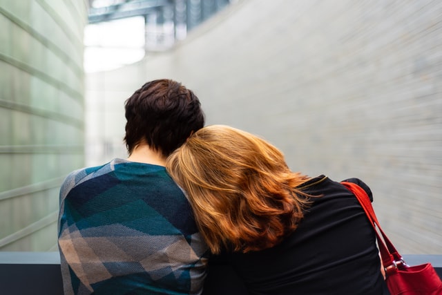 A friend comforting a person with PTSD