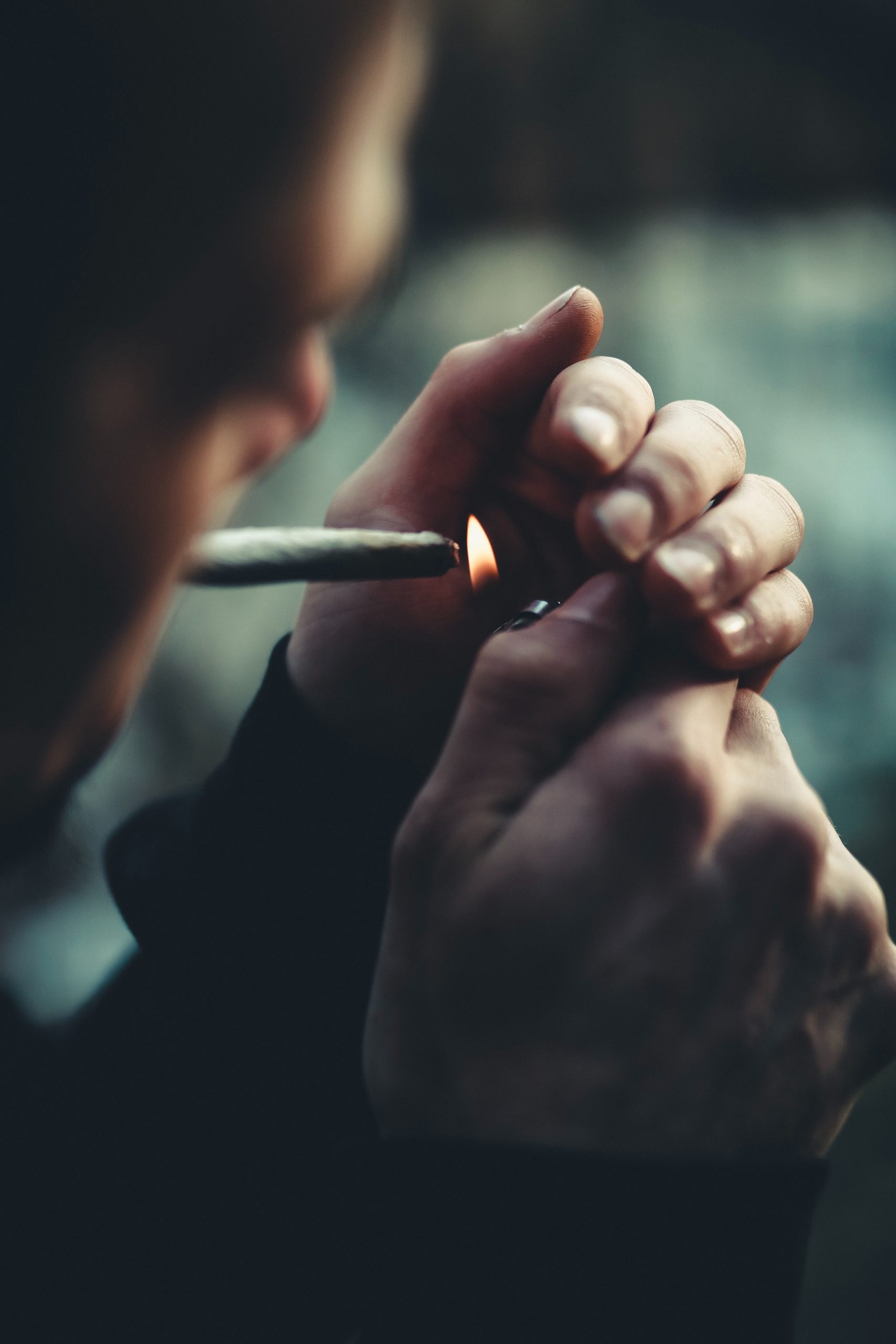 A man lighting a joint