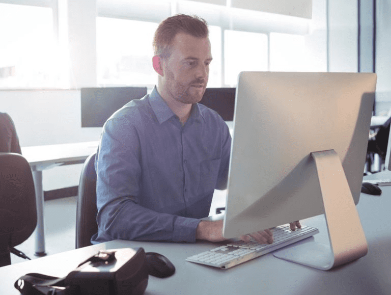 Man sitting at a desk using a computer