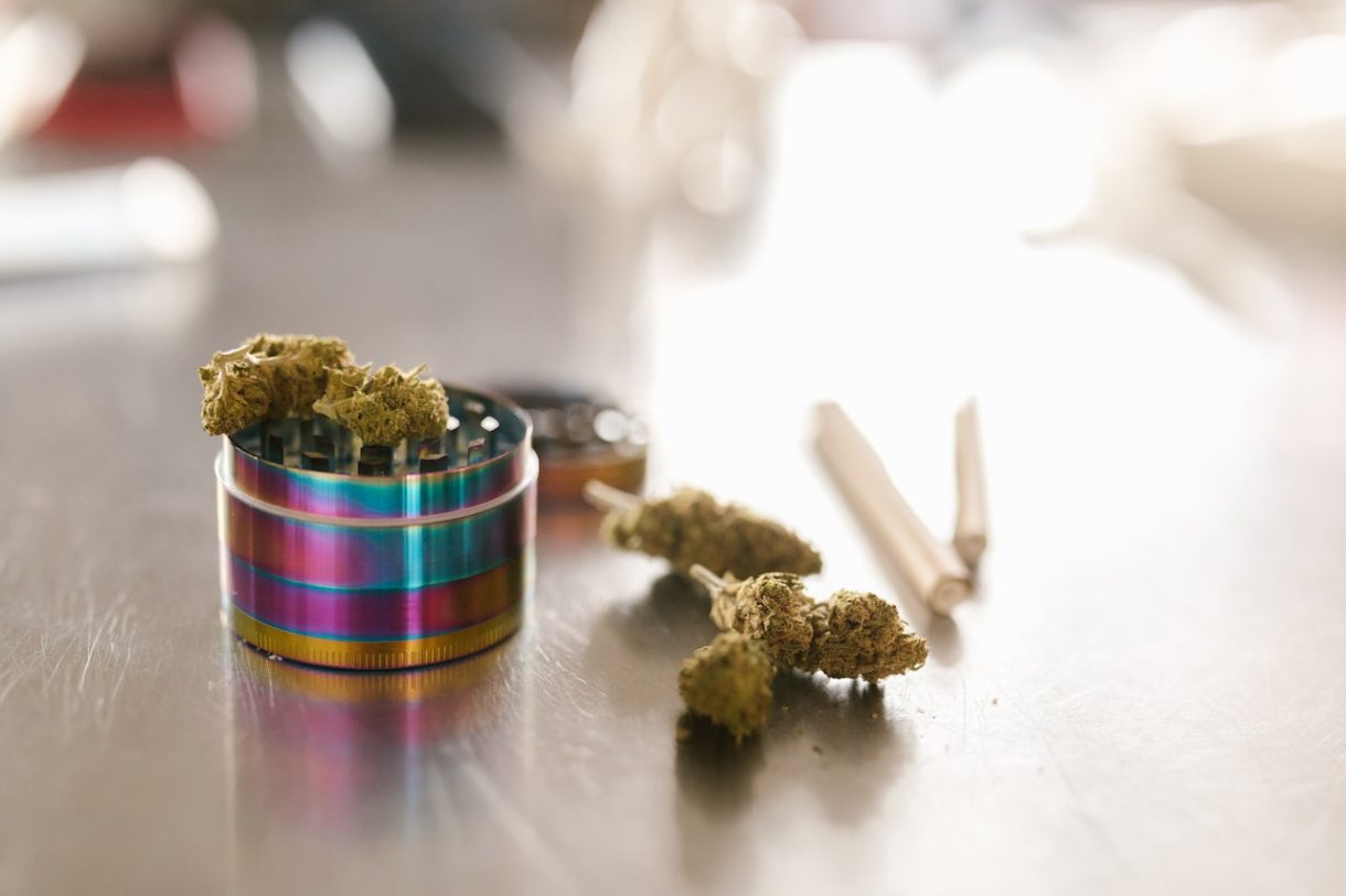 Cannabis buds and a grinder