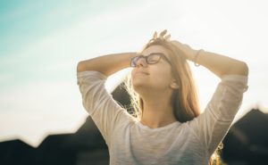 A happy woman touching her head