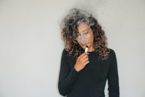 A woman vaping THC-O