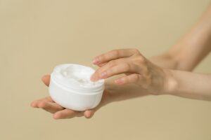 A woman using cannabis lotion