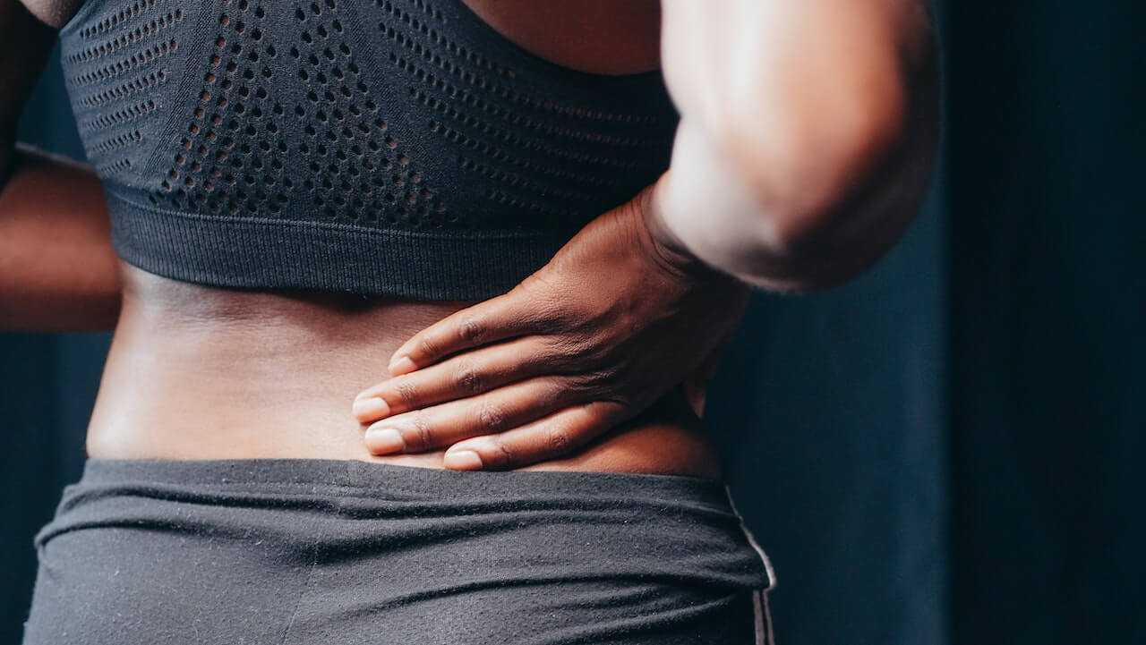 A woman touching her back