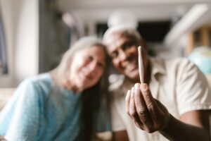 A couple holding a cannabis joint