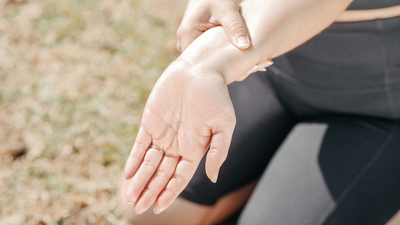 A woman holding her hand in pain