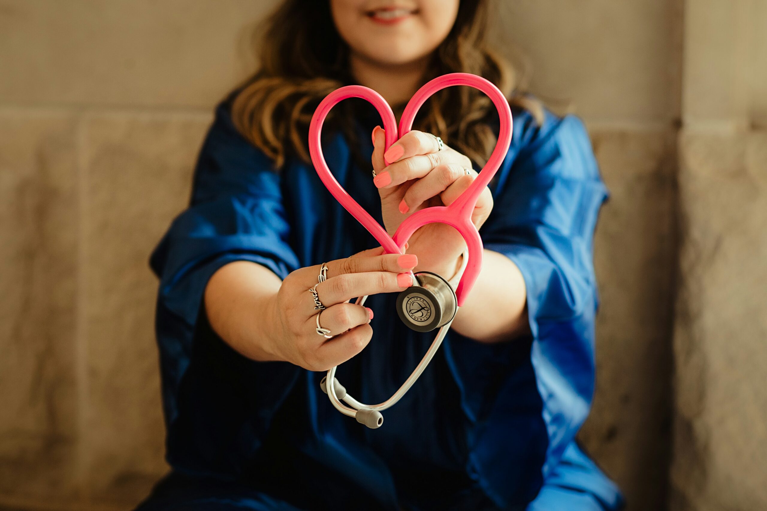 Patient holding a stethoscope shaped like a heart, symbolizing care and affordability in finding the cheapest Florida marijuana doctor.