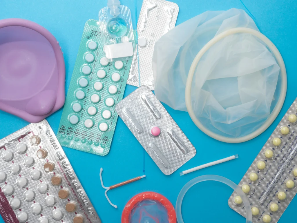 Cure for HIV concept image showing HIV prevention tools, medications, condoms, and reproductive health supplies.